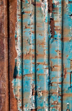 pattern rusty metal surface with remnants of blue paint close up