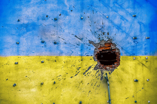 pattern explosion damaged blue yellow house wall war in Ukraine