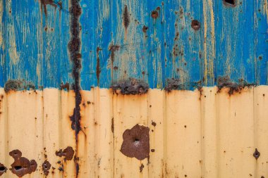 pattern explosion damaged blue yellow house wall war in Ukraine