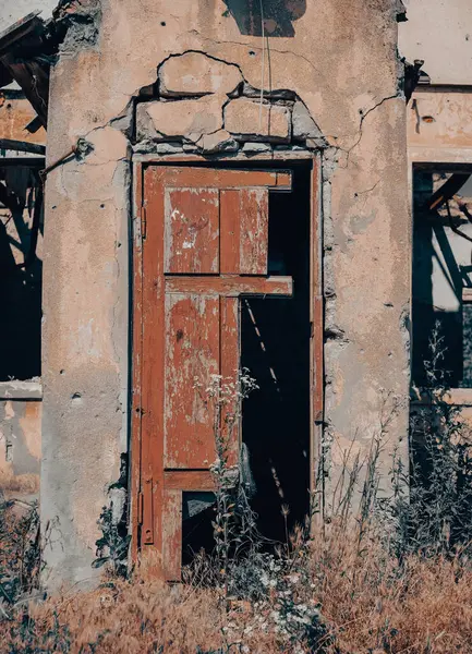 old broken wooden door of a destroyed house war in Ukraine