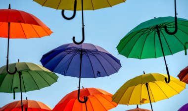 çok renkli şemsiyeler uçuyor ve soyut arka planda uçuyor.