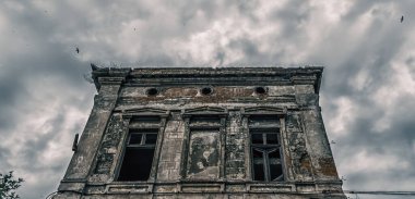 destroyed old building on a gloomy cloudy sky with birds clipart