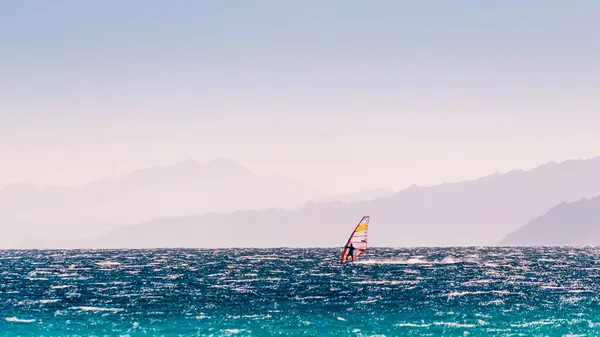 stock image windsurfer rides on a background of high mountains in Egypt Dahab South Sinai