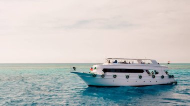 white cruise tourist boat on the background of the coast in the Red Sea in Sharm El Sheikh Egypt