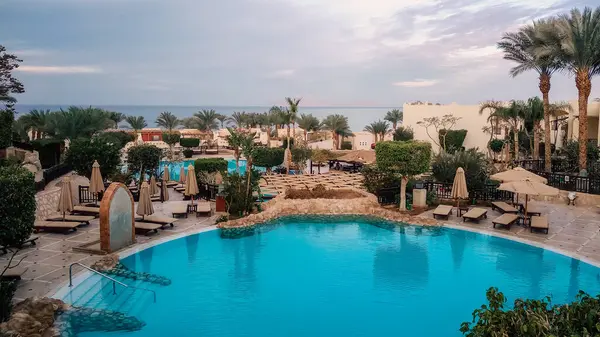 stock image empty hotel lawn with folded umbrellas on the coast of southern Sinai Egypt Sharm El Sheikh