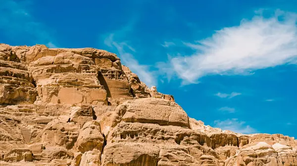 stock image high rocky mountains in the desert against the blue sky and white clouds in Egypt Dahab