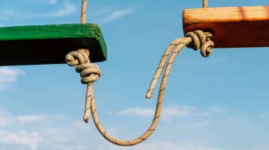 knot on a rope on a blue background close up clipart