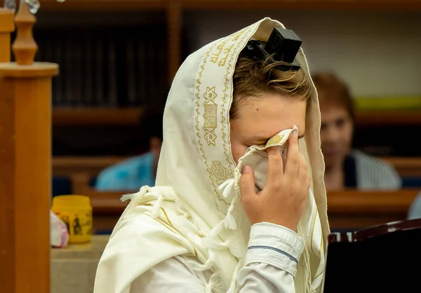 Celebrating a bar mitzvah in the city synagogue. Portrait of a boy. A young man performs a festive bar mitzvah ceremony. Israeli village Shlomi June 29, 2022