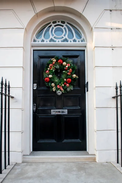 stock image Entrance doors of London houses. Festively decorated for Christmas front door of one of the houses