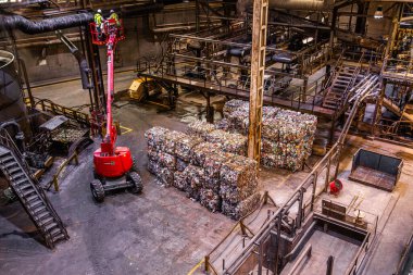 Industrial waste bales stacked for processing at a recycling facility. Waste-to-energy plant converting waste materials into usable energy and biogas, reducing landfill use and greenhouse gas emission clipart