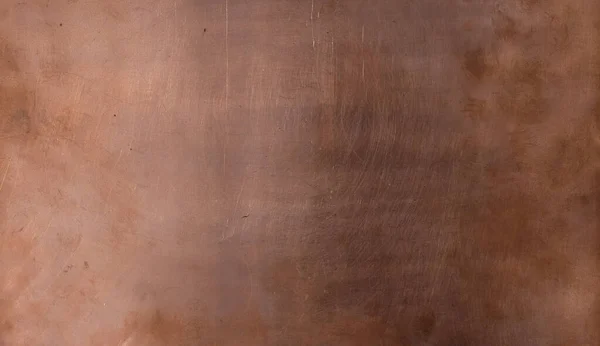 Copper sheet. Copper background for design. Different natural lighting. Scratches. Fingerprints.