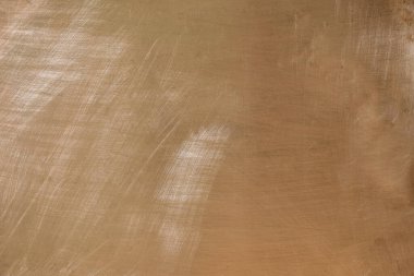 Hafif bakır yüzey. Bakır plaka. Doku. Sol doğal ışıklandırma. Tasarım için arkaplan.