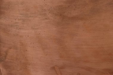 Bakır arka plan. Bakır yüzeyde çizikler var. Oksitlenmiş noktalar.