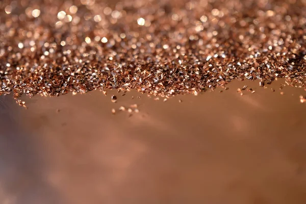 Copper shavings on the copper background. Copper glitter background bokeh. Copy space. Selective focus.
