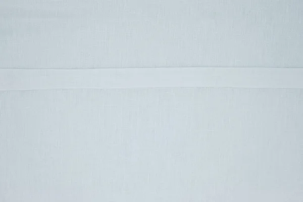 Modern linen fabric texture. Turned up edge. White background. Copy space.