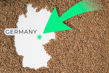 Almanya haritası buğday taneleriyle dolu. Yön yeşil ok. Boşluğu kopyala.