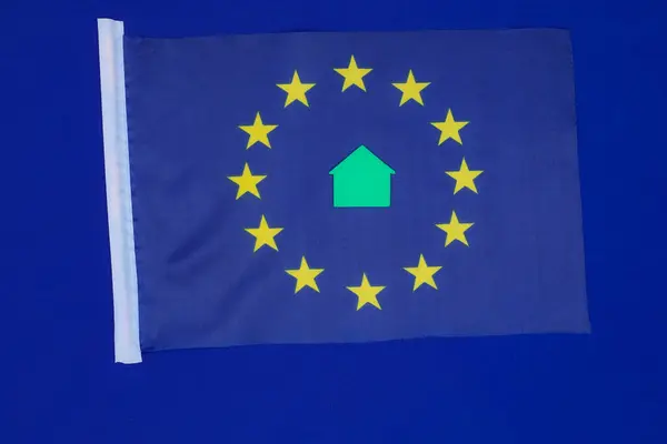 European Union flag. Green home. Concept. European Green Deal. Blue background. Top view.