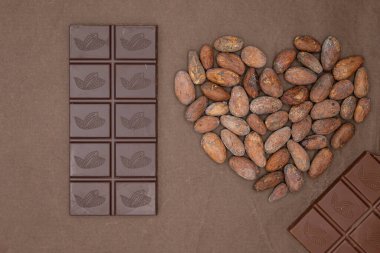 Types of chocolate bars. The heart is made from cocoa beans. Bean-to-bar chocolate production. Different varieties of cocoa beans. Warm Mocha Mousse 2025 color trend. clipart