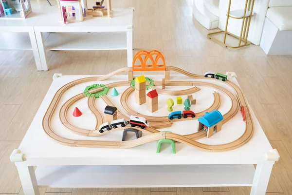 a wooden electric train and railway toy set for children in a daycare place and indoor playground.