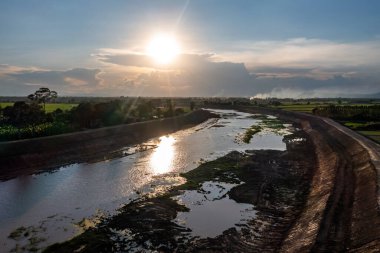 Construction dredges up for a canal and dam, to prevent a flood in the rainy season. Date on 14 May 2021 at Uthai Thani province, Thailand. clipart