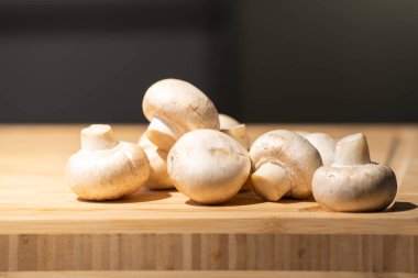 Straw mushroom is prepared on the wood board for ingredient of cooking. clipart