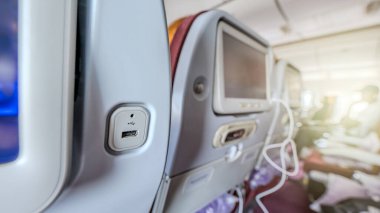 Convenience meets travel with USB ports at airplane seats, providing a practical solution for charging electronic devices on the go. clipart