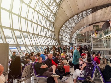 Bangkok, Thailand - 9 July 2023, Suvarnabhumi Airport Gate C2, Passengers gather, ready to board Thai Airways flight to Heathrow, London, England. clipart