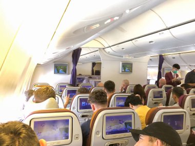 Samut Prakan, Thailand - 9 July 2023, Inside TG916 Thai Airways Plane, Capturing the passenger environment on the seats before takeoff from Bangkok to Heathrow, London. clipart