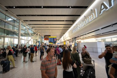 London, England - 10 July 2023, Environment Inside Heathrow International Airport Showcasing Modern Interior Design at the evening time with passengers. clipart