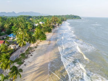 Palmiye ağaçları, ince kum ve köpük dalgalarıyla berrak gökyüzünün ariel görüntüsü Chumphon, Tayland 'daki sakin plajlara sıçradı..