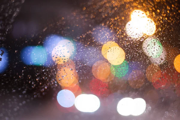 stock image Blurred background with raindrops and lights.