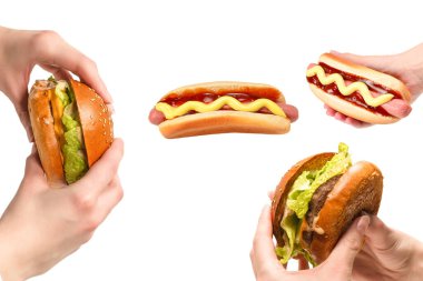 Hamburger, beyaz bir arka planda izole edilmiş bir şekilde kadınların elinde. Üst görünüm. 