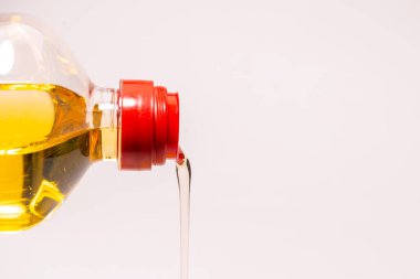 A bottle of sunflower oil isoalted on a white background. Oil pouring from a bottle.