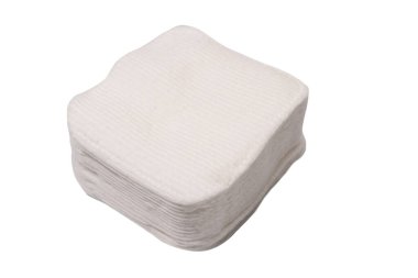 Stack of white cotton sponges isolated on a white background.