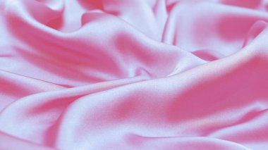 Soft pink and blue silk or satin luxury fabric texture. Top view.