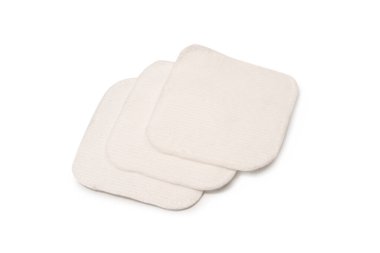 Stack of white cotton sponges isolated on a white background.