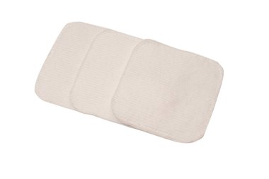 Stack of white cotton sponges isolated on a white background.