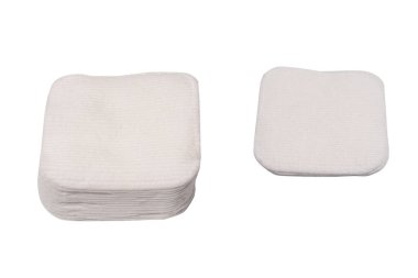 Stack of white cotton sponges isolated on a white background.