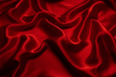Kırmızı ipek ya da saten lüks kumaş dokusu soyut bir arka plan olarak kullanılabilir. Üst görünüm.