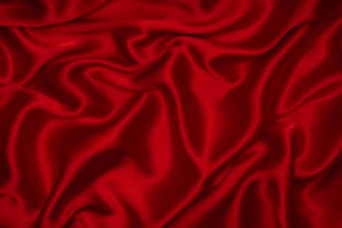 Kırmızı ipek ya da saten lüks kumaş dokusu soyut bir arka plan olarak kullanılabilir. Üst görünüm.