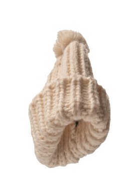 Beige warm beanie hat with pom pom isolated on a white background. 