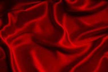 Kırmızı ipek ya da saten lüks kumaş dokusu soyut bir arka plan olarak kullanılabilir. Üst görünüm.