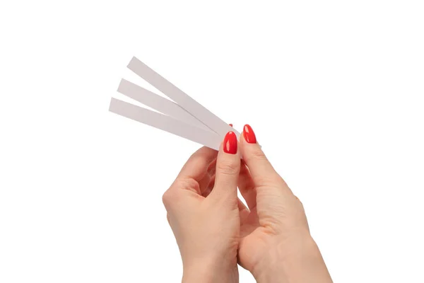 stock image Woman hand with red nails with test strips for the perfume, isolated on a white background. Perfume blotters.