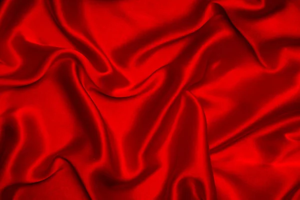 赤いシルクやサテンの高級生地のテクスチャは抽象的な背景として使用することができます トップ表示 — ストック写真