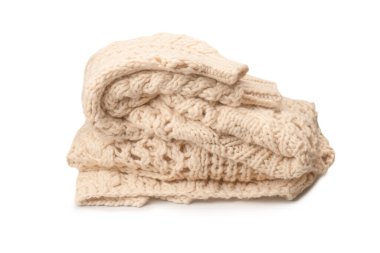A fragment of beige knitted fabric, knitted from white sheep wool. Knitted background. 