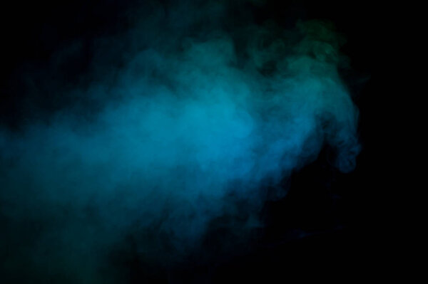 Blue and green steam on a black background. Copy space.