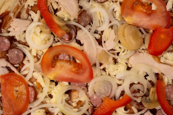 stock image Tasty pizza with salami, sausages, cheese, onions and sauce.