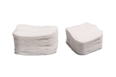 Stack of white cotton sponges isolated on a white background.