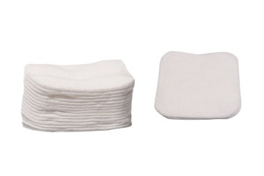 Stack of white cotton sponges isolated on a white background.
