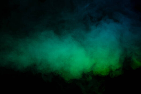 Blue and green steam on a black background. Copy space.